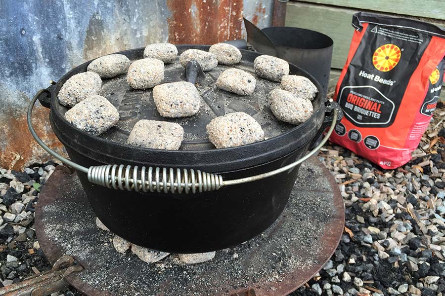 Camp Oven on bed of coals away from main fire