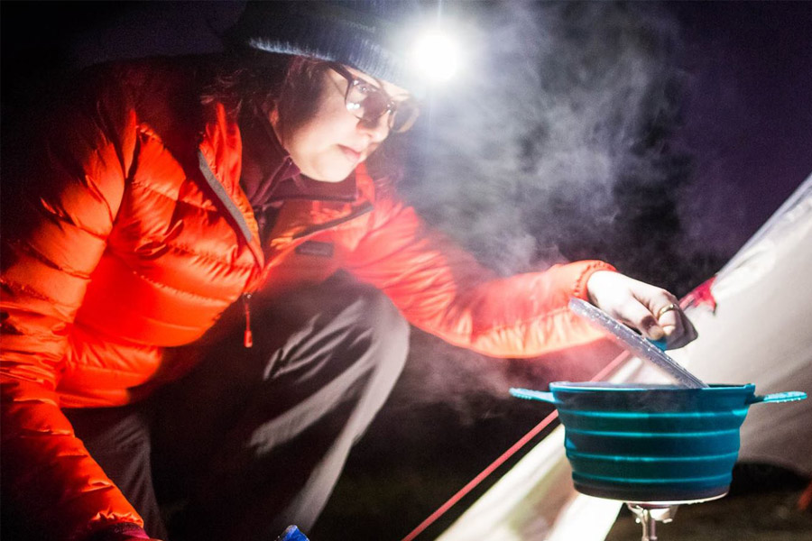 Woman using headlamp to see her cooking