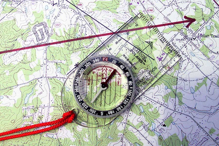 Pivot compass around landmark until orienting lines match map grid lines