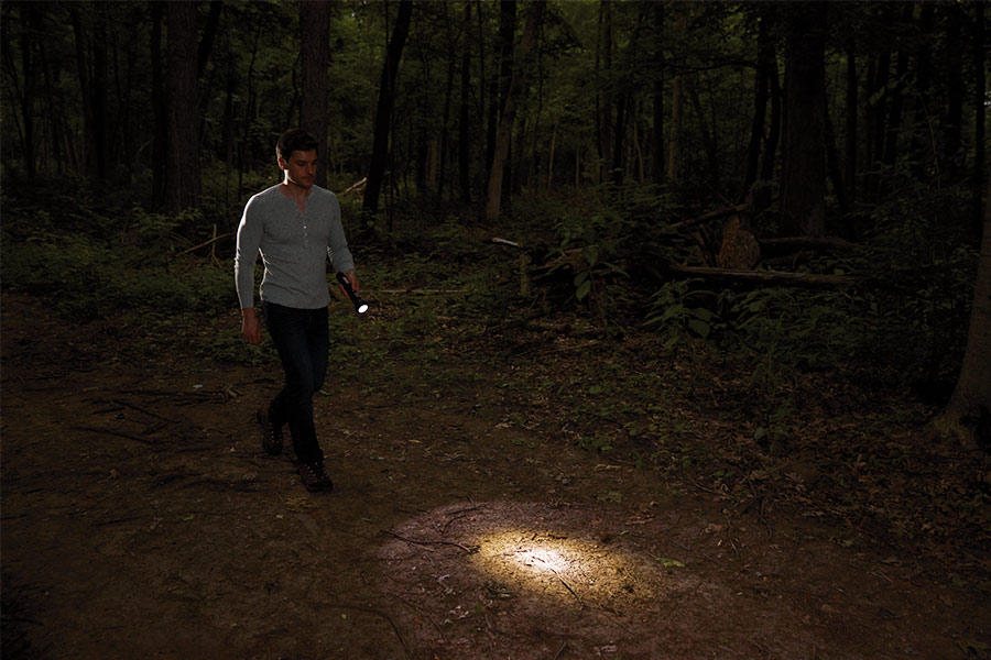 Man walking with torch at night outdoors