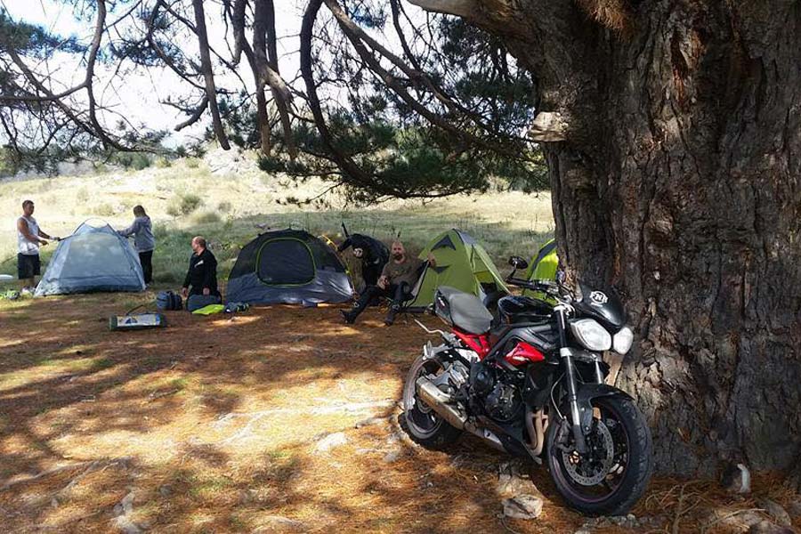 Motorcyclists setting up tents to camp out for the night