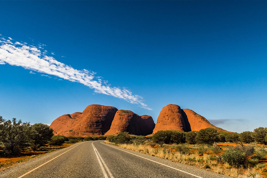 An open outback road with a vivid blue sky.