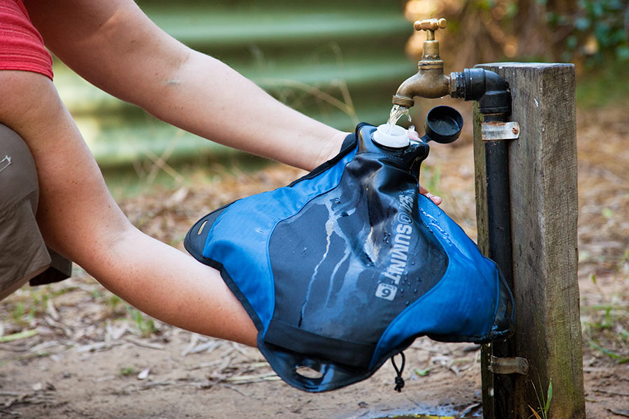 A pack tap being filled under a running outdoor tap