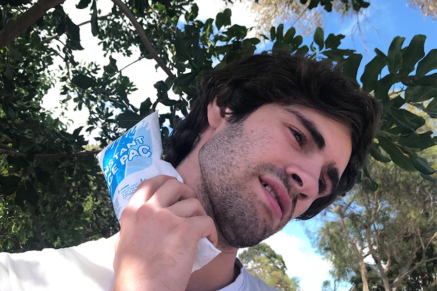 Hiker putting Instant Ice Pack on his neck