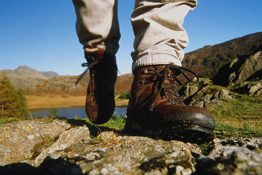 Hiker walking with leather boots on