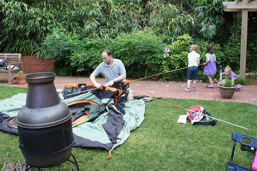 Setting up a tent in the backyard with the family