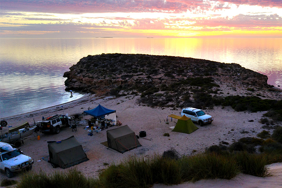 People setting up camp for the night on a beach at Carrarang Station