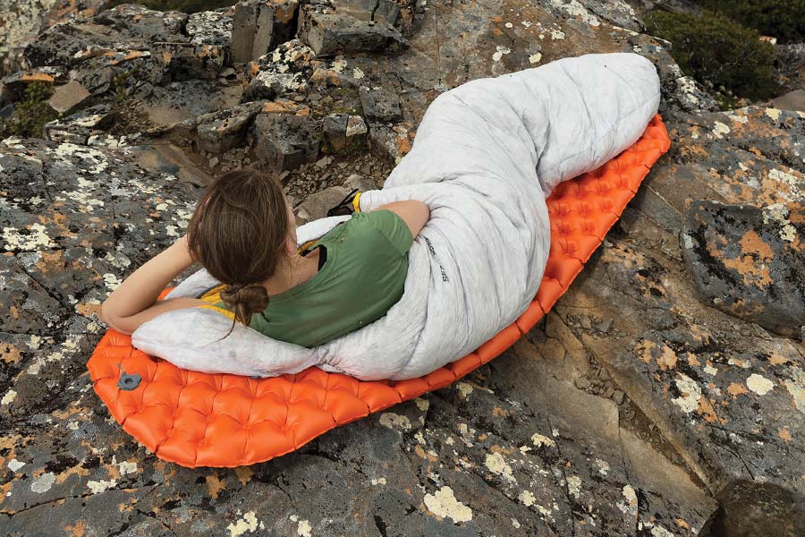 Woman lying on air filled Sea to Summit Mat