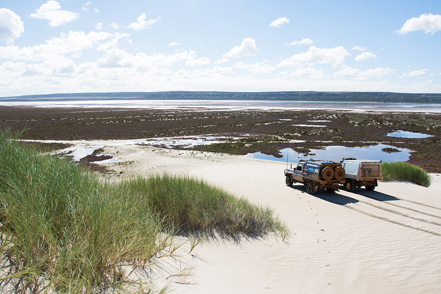 Two 4WDs on a sandy bank. 