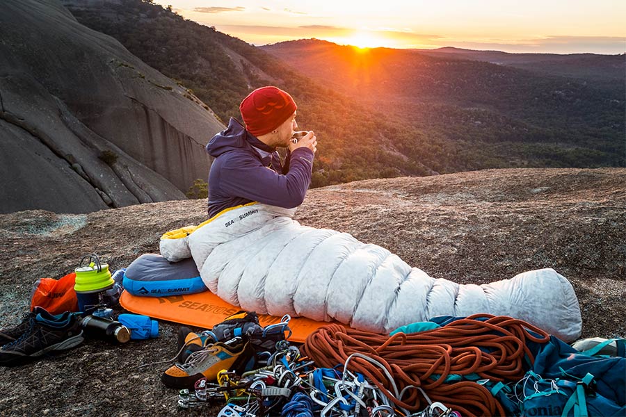 Man laying on a Sea to Summit self-inflating mat