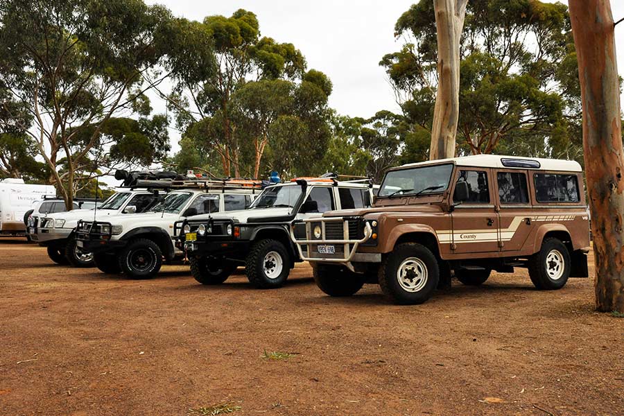Four 4WDs in a row at a caravan park. 