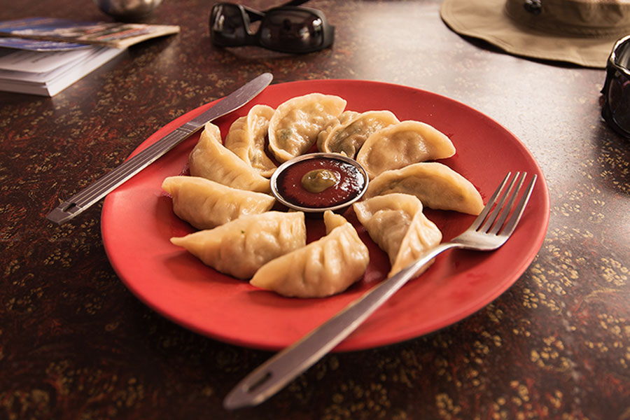 A plate of delicious dumplings with sauce