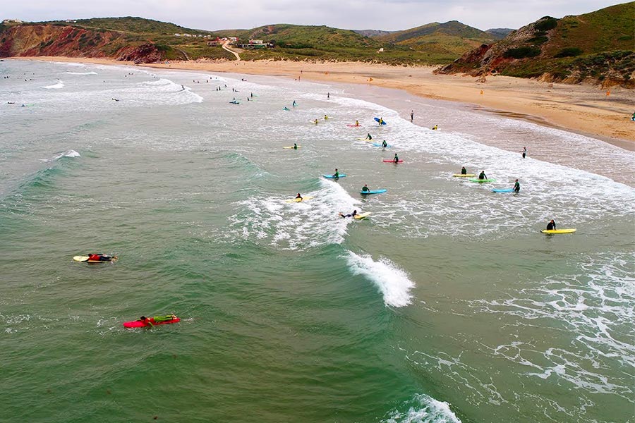Bird's eye view of surfers at Amado beach in Portugal