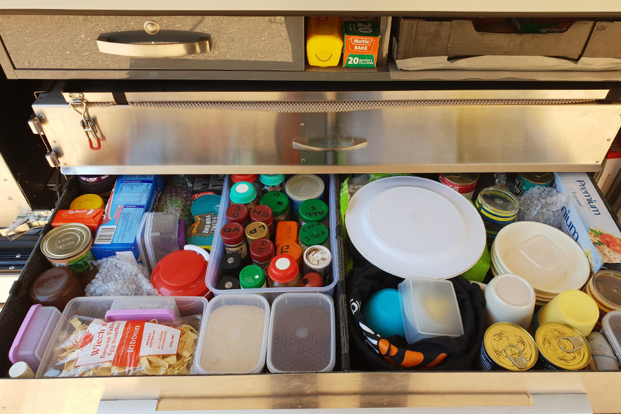 View of packed kitchen drawer in caravan