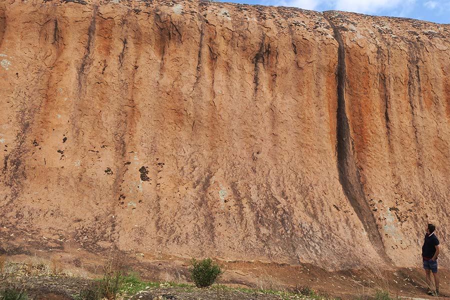 Man standing next to an unusual granite intrusion - Pildappa Rock