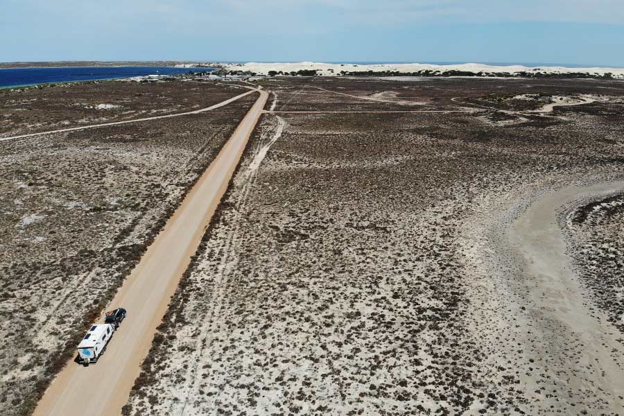 A 4WD towing a Caravan down a remote road