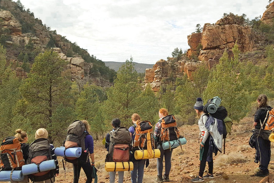 A group of teenage hikers with packs.