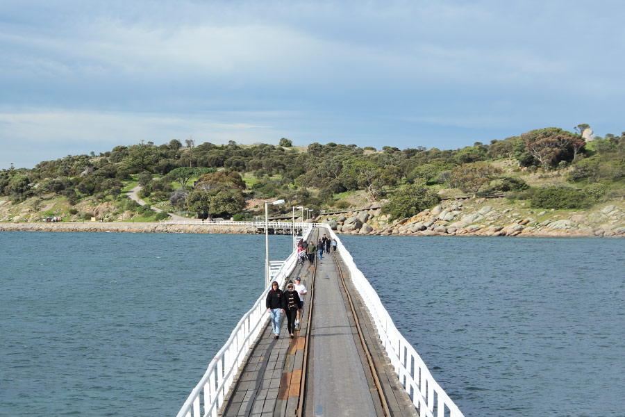People walking on the bridge to Granite Island