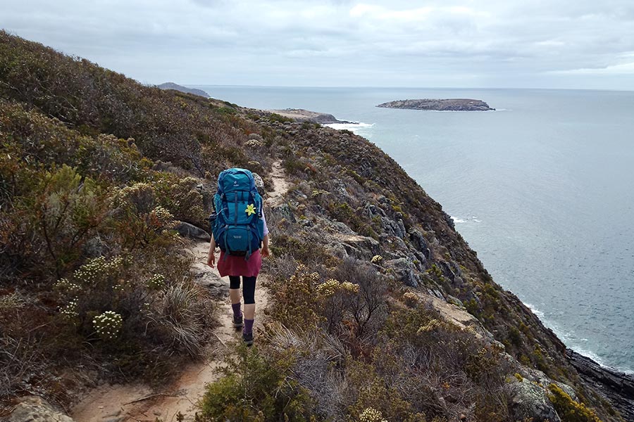 Woman walking with hiking pack along Heysen Trail 