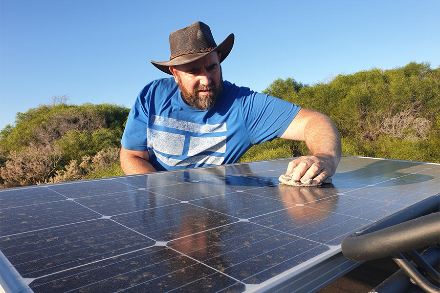Man cleaning solar panel