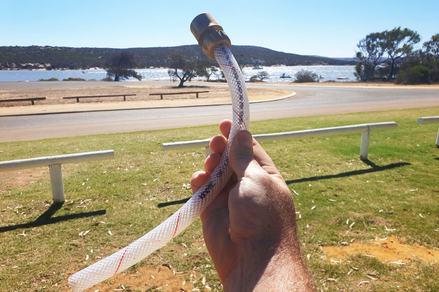 Man holding water-filling device in his hand outside