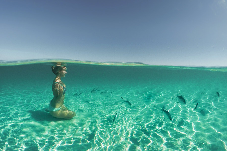 Woman underwater with fish in Turquoise Bay, WA