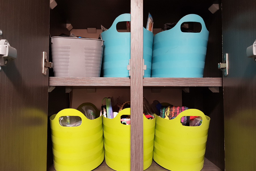 Tubs in caravan cupboard organising stationery