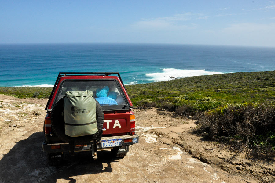 Vehicle parked along 3 Bears Track looking over the ocean
