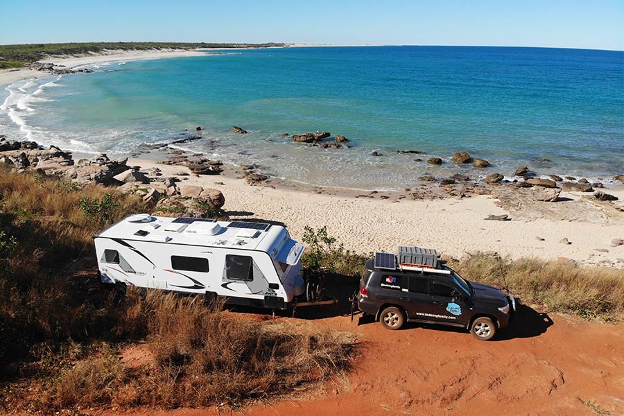 4WD towing a caravan by the beach