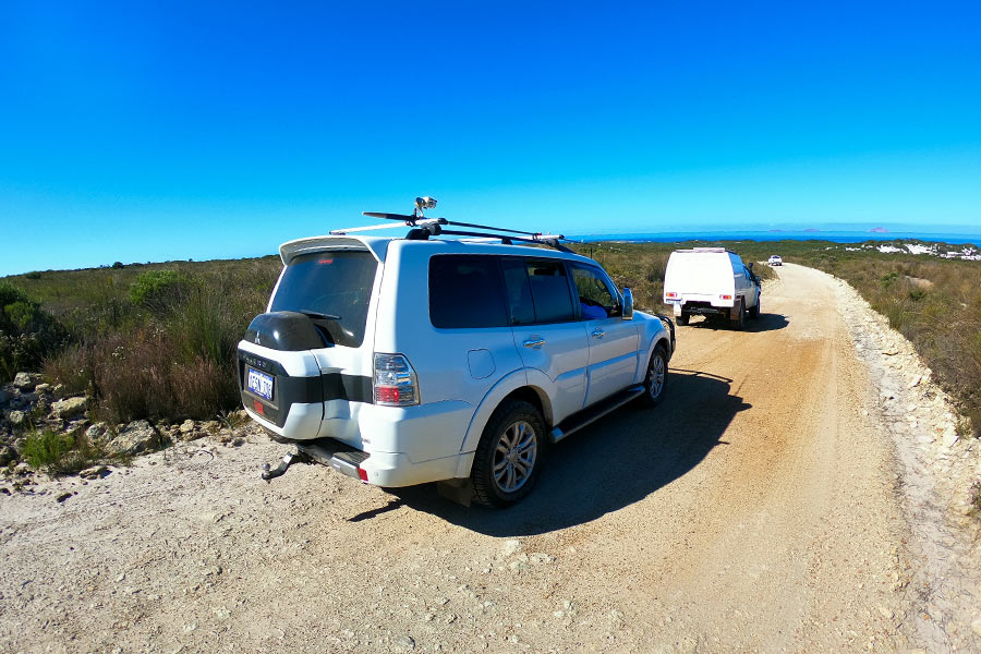 View of 4WD driving away on outback road