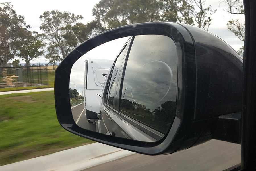 4WD side mirror showing caravan reflection