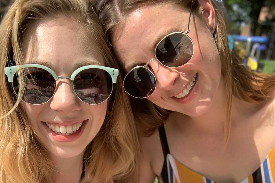 Two friends posing for a photo with their sunnies on