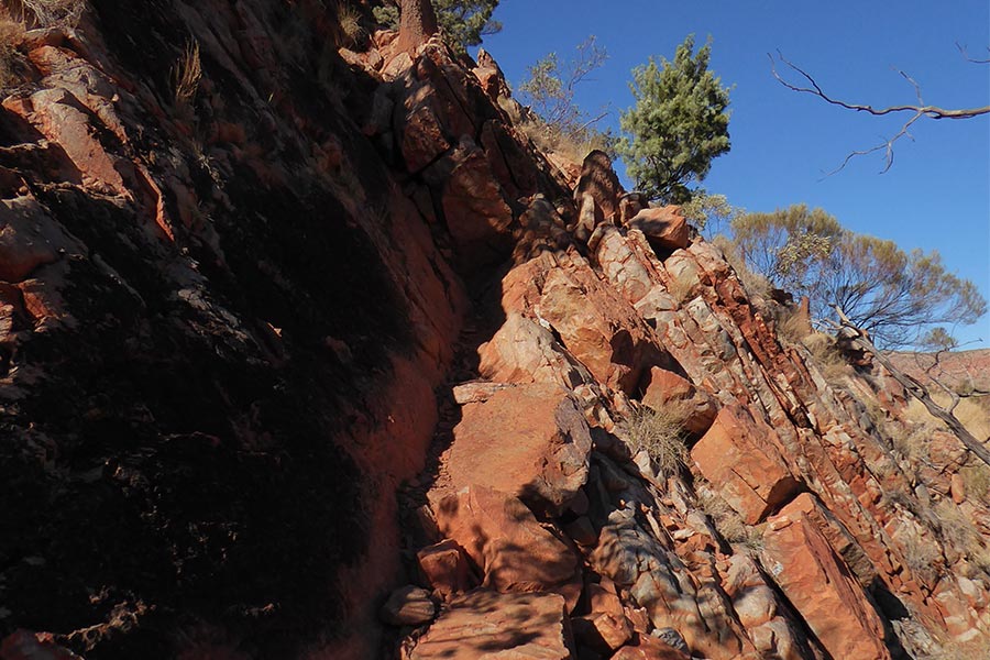 Steep rocky cliff face that is part of the Larapinta Trail