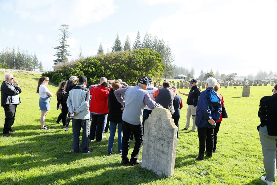 People listening in on a cemetery tour in Norfolk Island