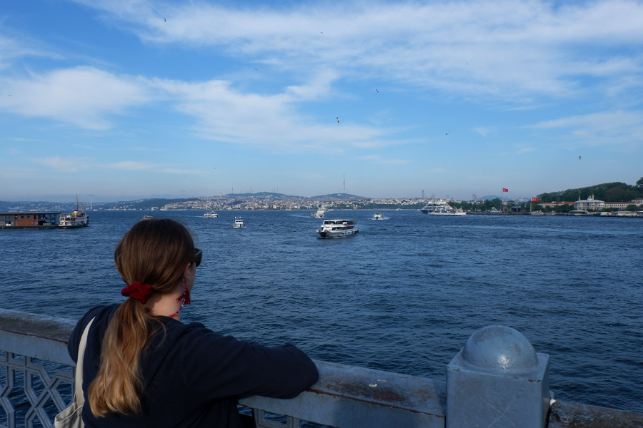 Woman standing on ferry looking out over Istanbul