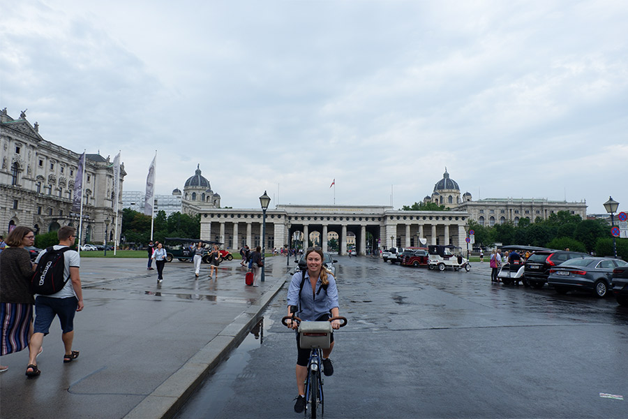 Woman cycling along a street in Vienna, Austria