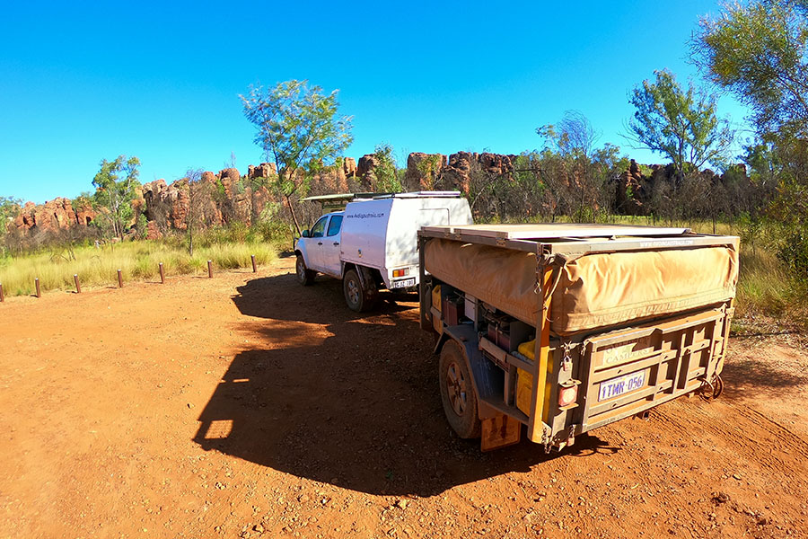 A 4WD and camper trailer parked in the outback. 