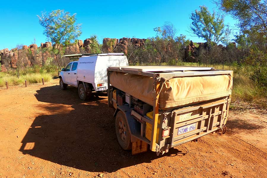 Vehicle towing a camper trailer throughout the NT on a hot day