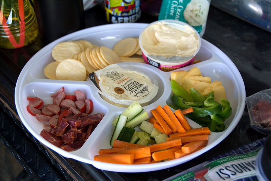 Platter full of deli meats, crackers, veggies and dip