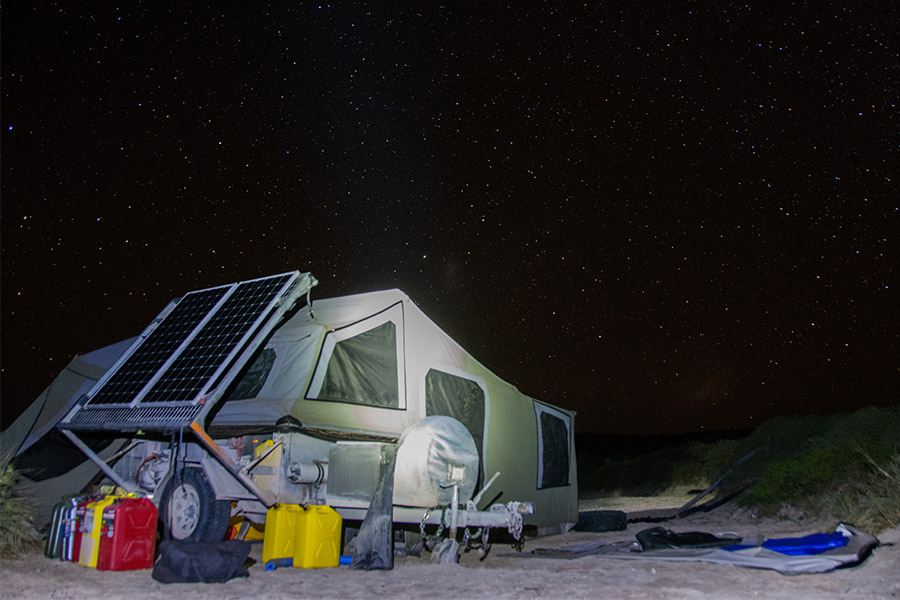 Camper tralier setup at night in a remote location