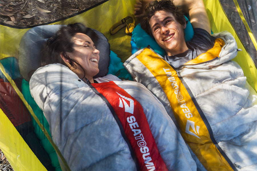 Man and woman lying in their Sea to Summit sleeping bags