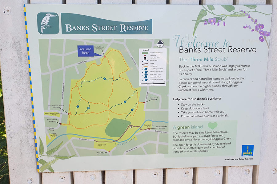 A sign on a fence that reads 'Welcome to Banks Street Reserve' and includes a map of the trails