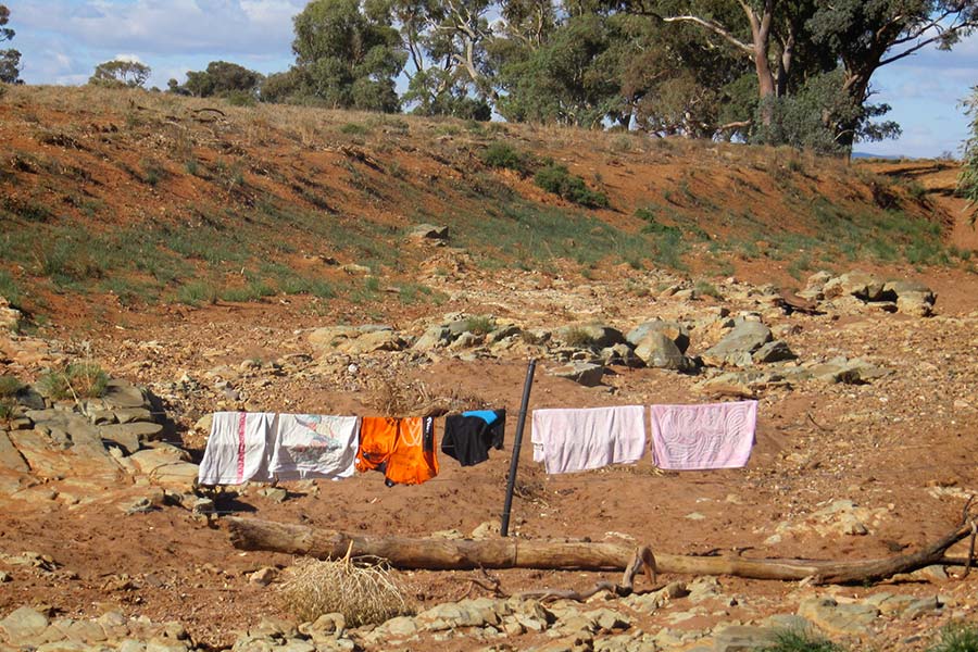 Clothing hanging on the fence line in the outback.