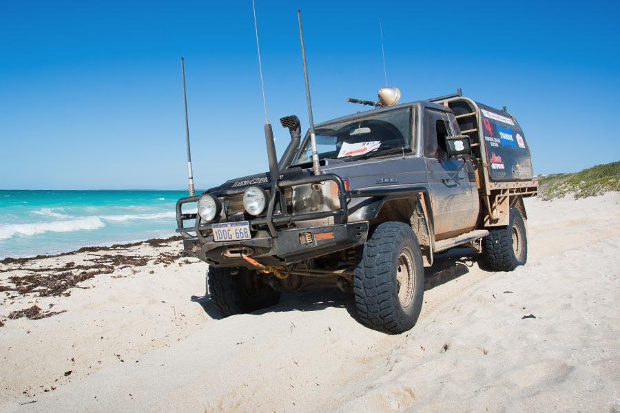 A 4WD vehicle on a sandy beach