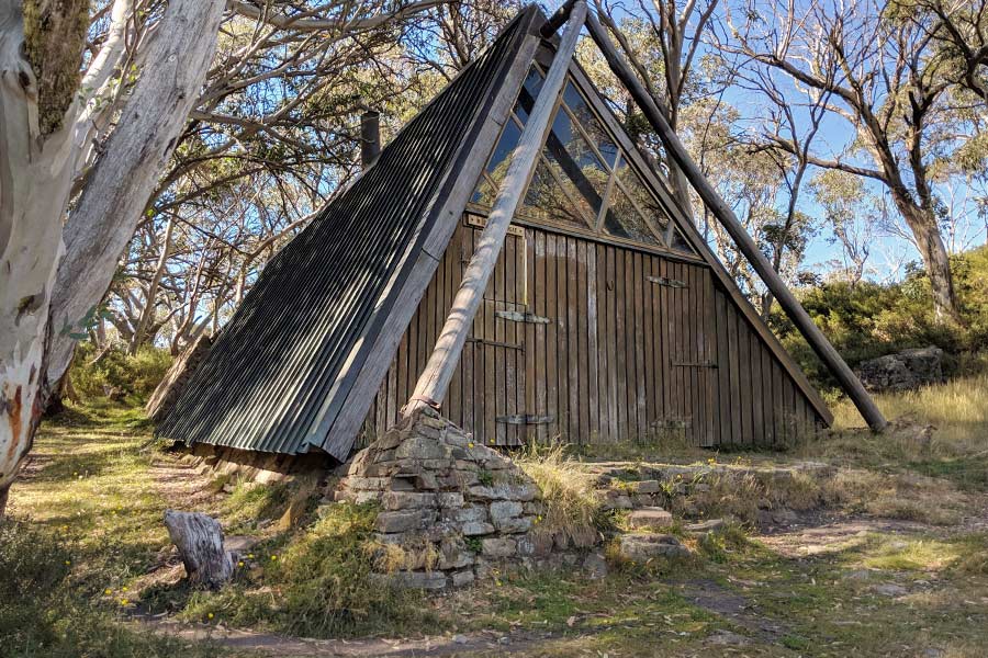 An unusually shaped A-frame basecamp hut made with timber construction and copper cladding