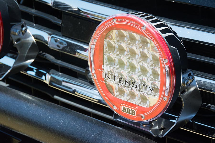 A close up photo of an ARB Intensity LED spotlight mounted on the front of a car