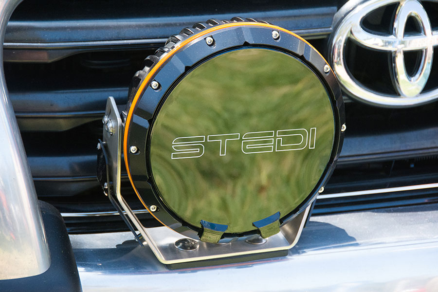 A Stedi branded spotlight mounted on the front of a car