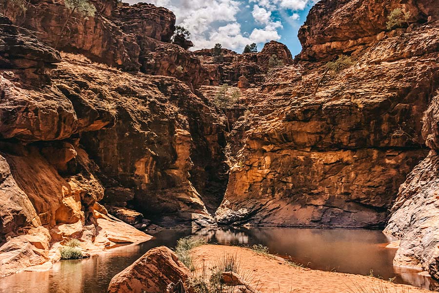 The spectacular rock faces of Mutawintji Gorge with the waterhole below.