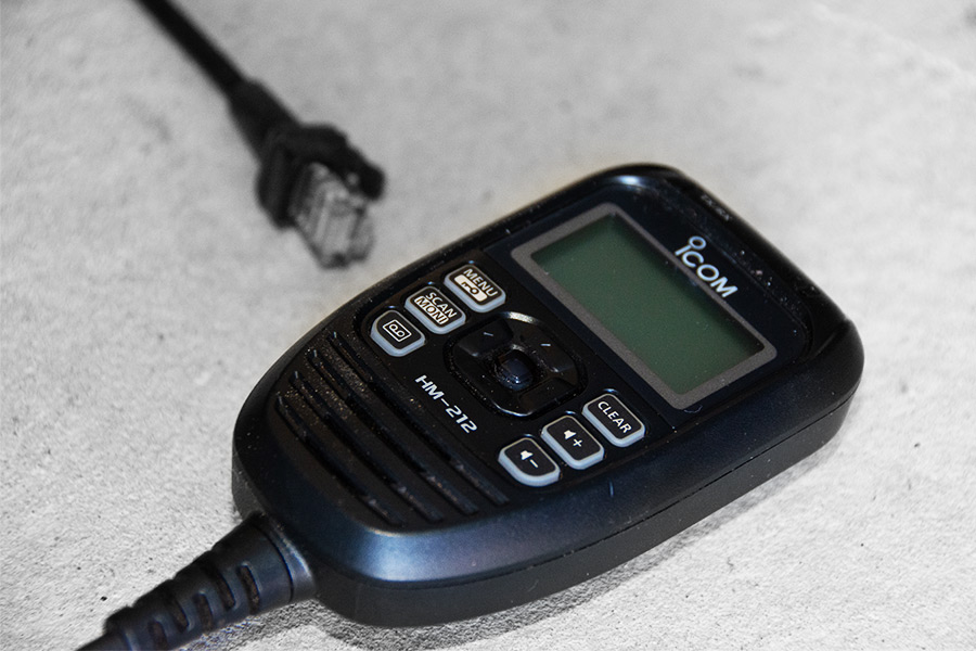 A black Icom UHF radio handset.