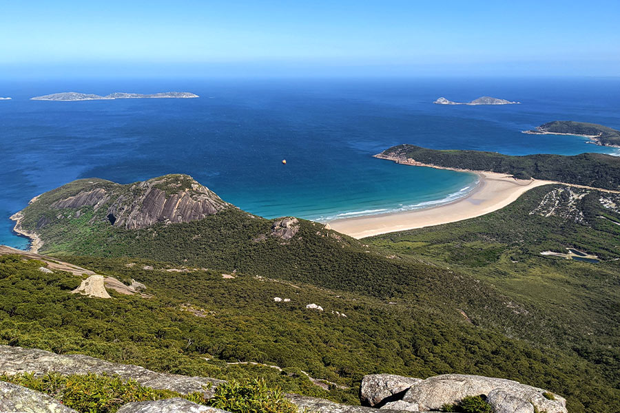 This iconic hike makes a steady incline with the final ascent becoming steep and narrow. View from the summit of Mt Oberon, looking over the many hidden coves and their white beaches.
